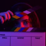 Girl with a clapperboard on how to take action