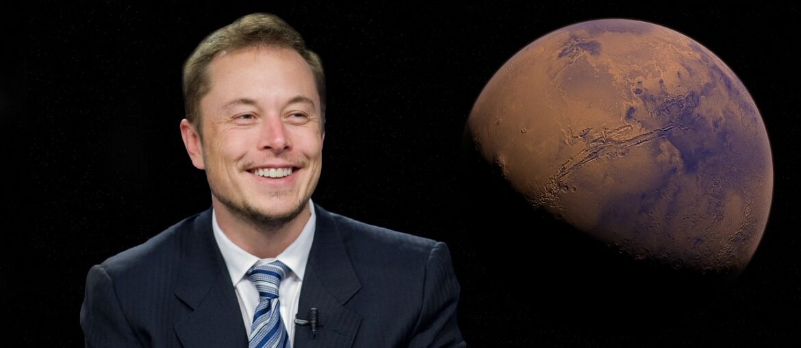 Elon Musk in blue suit smiling while image of mars shows behind